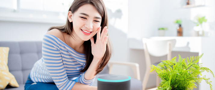 woman at home speaking to AI assistant woman at home speaking to AI assistant